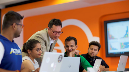 Lecturer working with students in Cloud Competency Centre in NCI